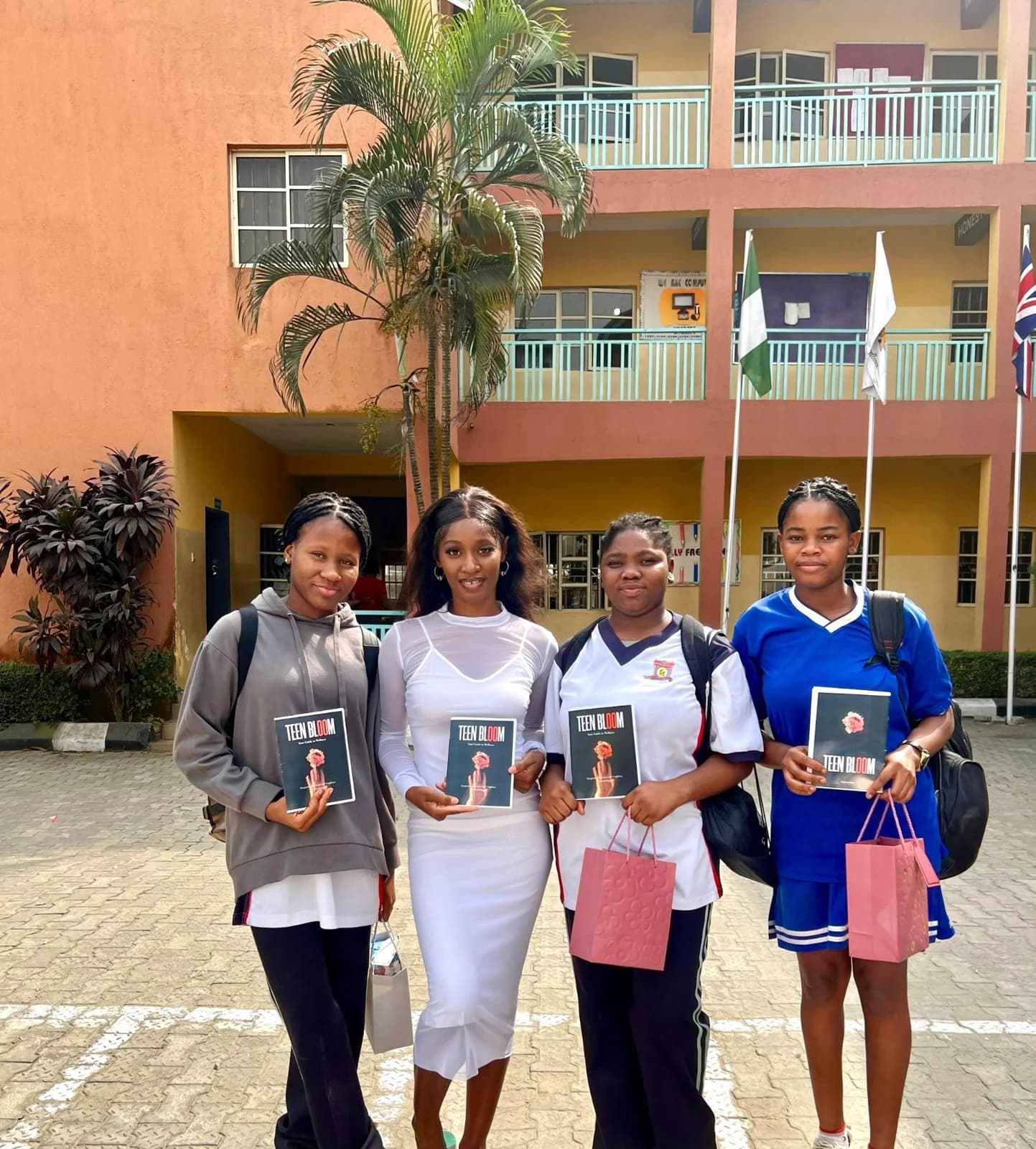 Students and an Ecclesia representative holding Teen Bloom booklets